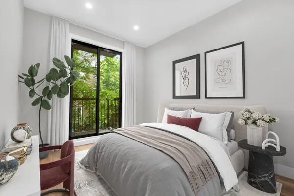 a bedroom with a bed and a large window