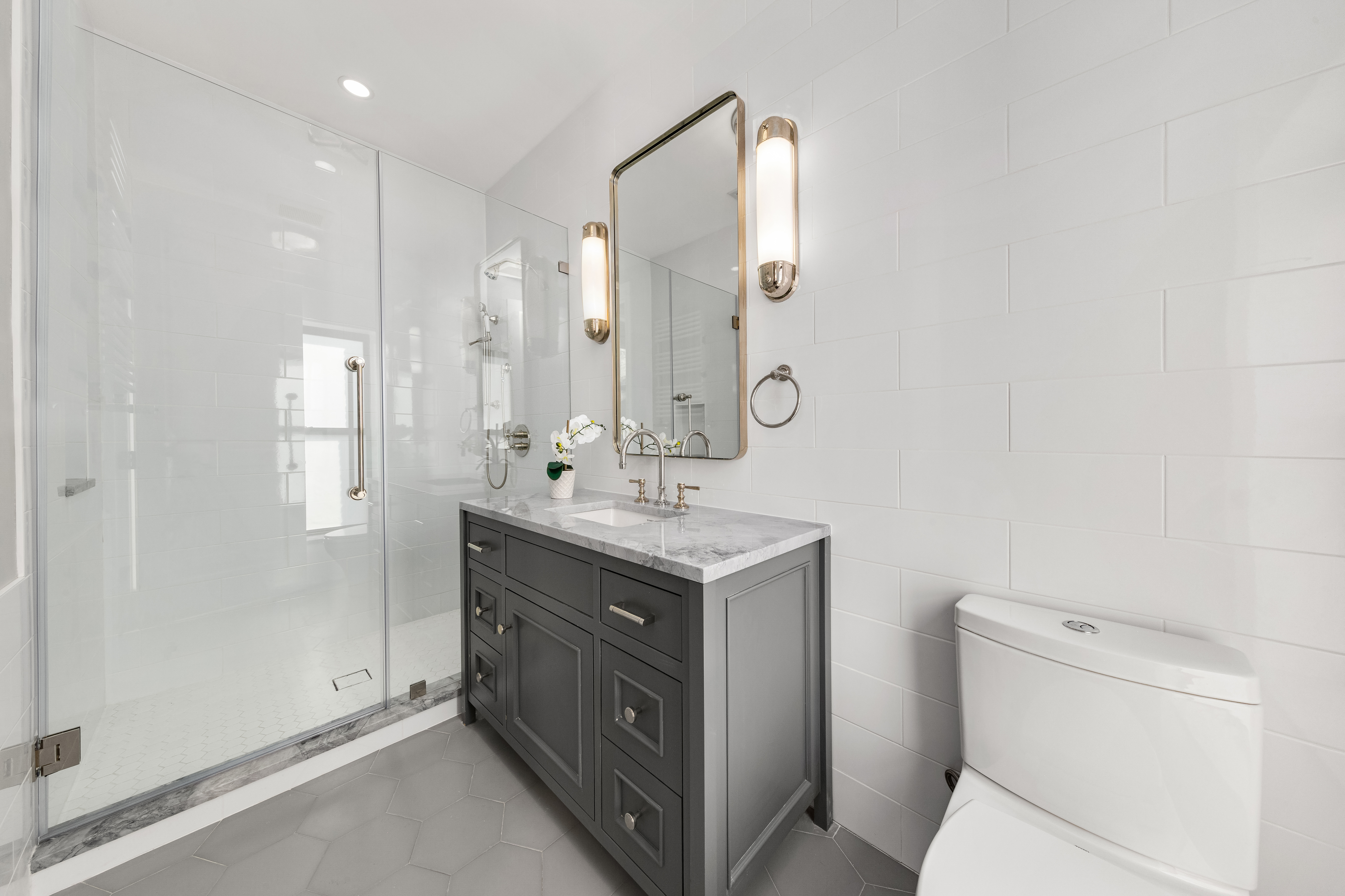 110 West 81st Street Manhattan, NY 10024 - Photo 23 of 30 a bathroom with a sink mirror vanity and toilet