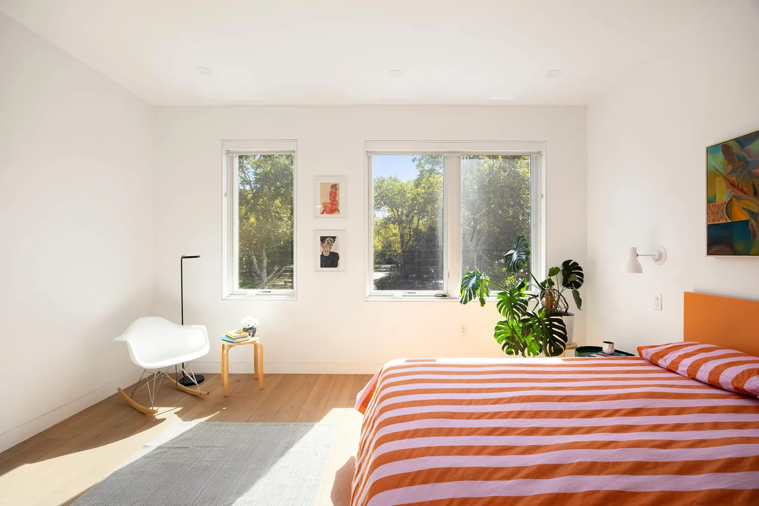 a bedroom with a bed and potted plant