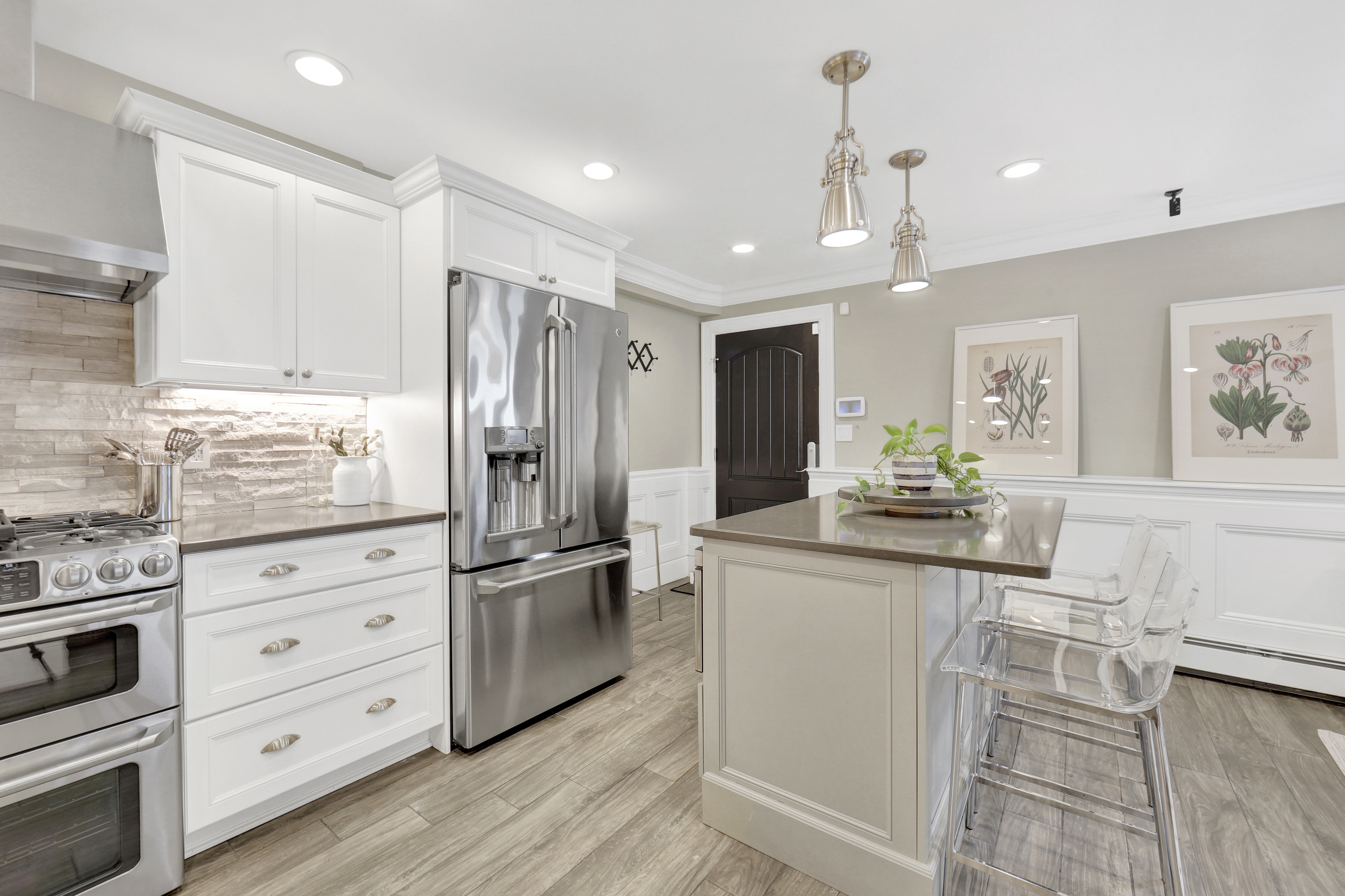 1-69 Beach 98th Street, Unit 1 Queens, NY 11694 - Photo 7 of 23 a kitchen with stainless steel appliances kitchen island granite countertop a refrigerator and a stove top oven