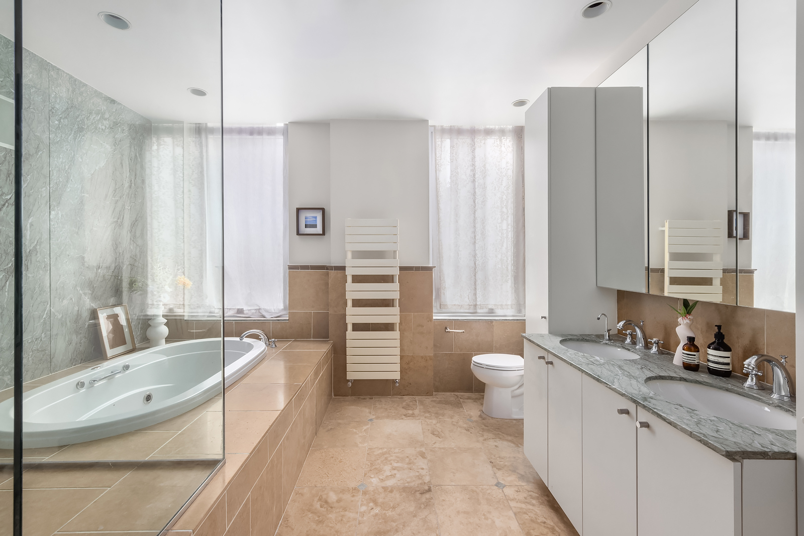 114 Liberty Street, Unit 7 Manhattan, NY 10006 - Photo 13 of 15 a spacious bathroom with a granite countertop tub sink and mirror