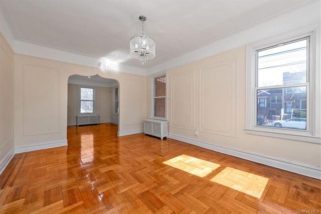 1186 Brooklyn Avenue, Unit N A Brooklyn, NY 11203 - Photo 6 of 17 a view of an empty room with window and wooden floor