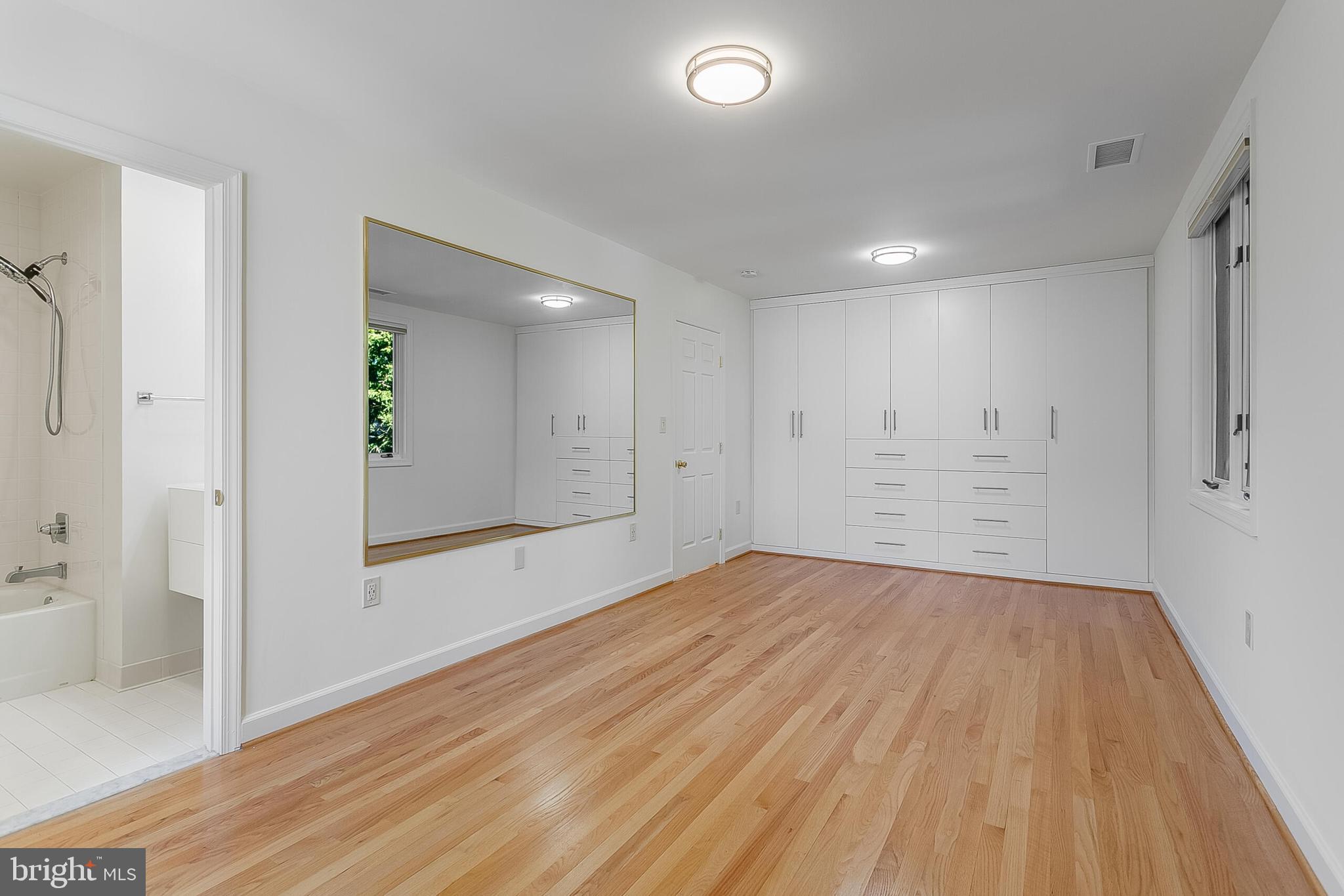 4709 Foxhall Crescent Northwest Washington, DC 20007 - Photo 47 of 57 a view of an empty room with wooden floor and a bathroom