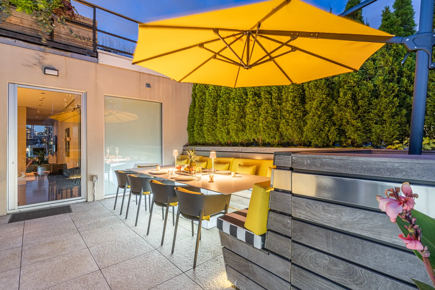 a view of an outdoor sitting area with furniture and umbrella