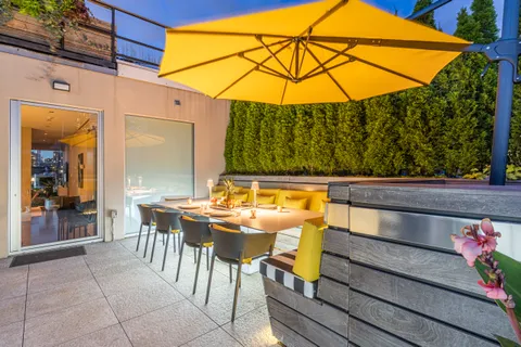 a view of an outdoor sitting area with furniture and umbrella