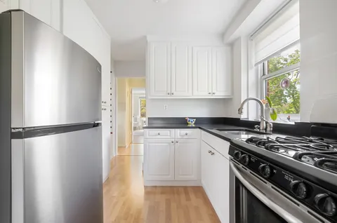 a kitchen with a stove a refrigerator and a stove