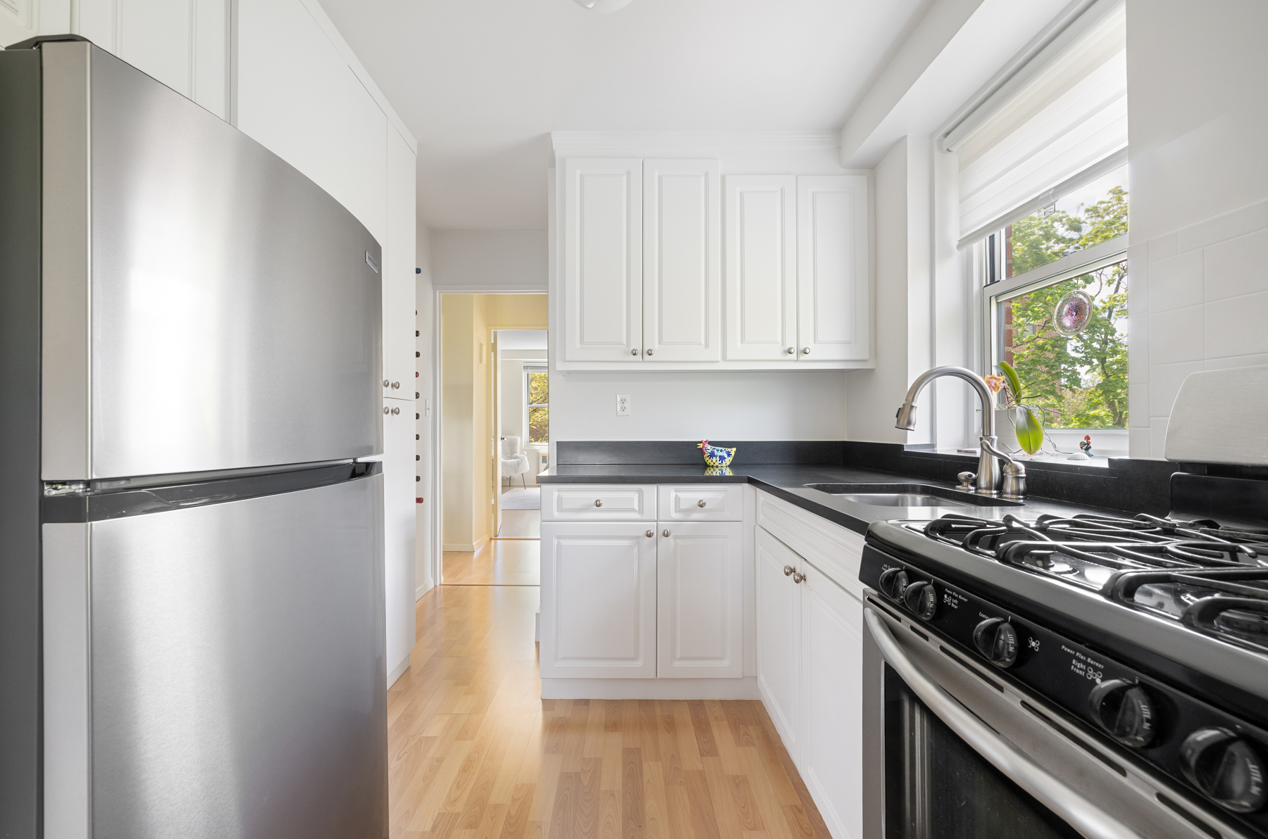 35-11 85th Street, Unit 5H Queens, NY 11372 - Photo 7 of 11 a kitchen with a stove a refrigerator and a stove