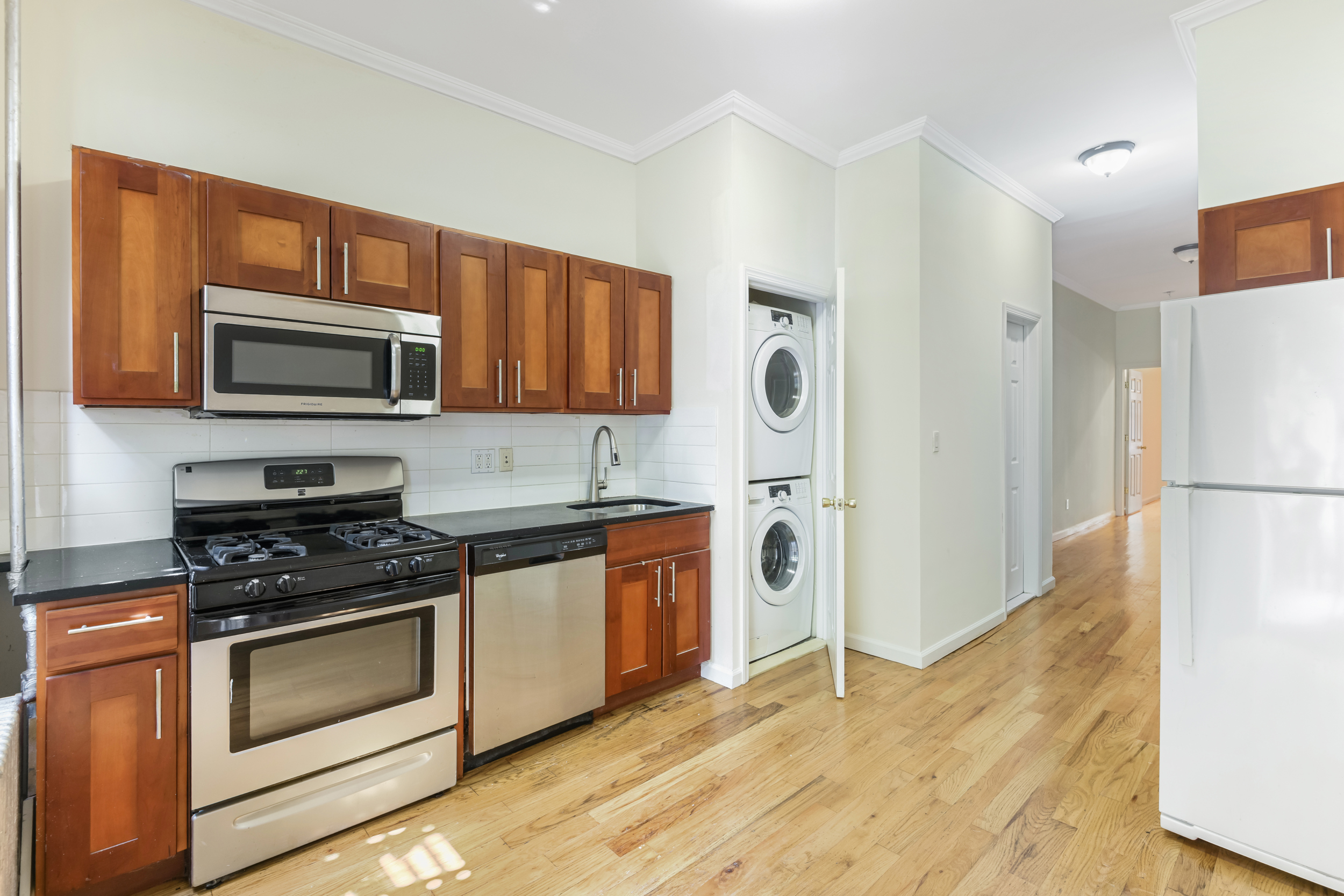 262 12th Street, Unit 1L Brooklyn, NY 11215 - Photo 1 of 10 a kitchen with granite countertop a refrigerator stove and microwave
