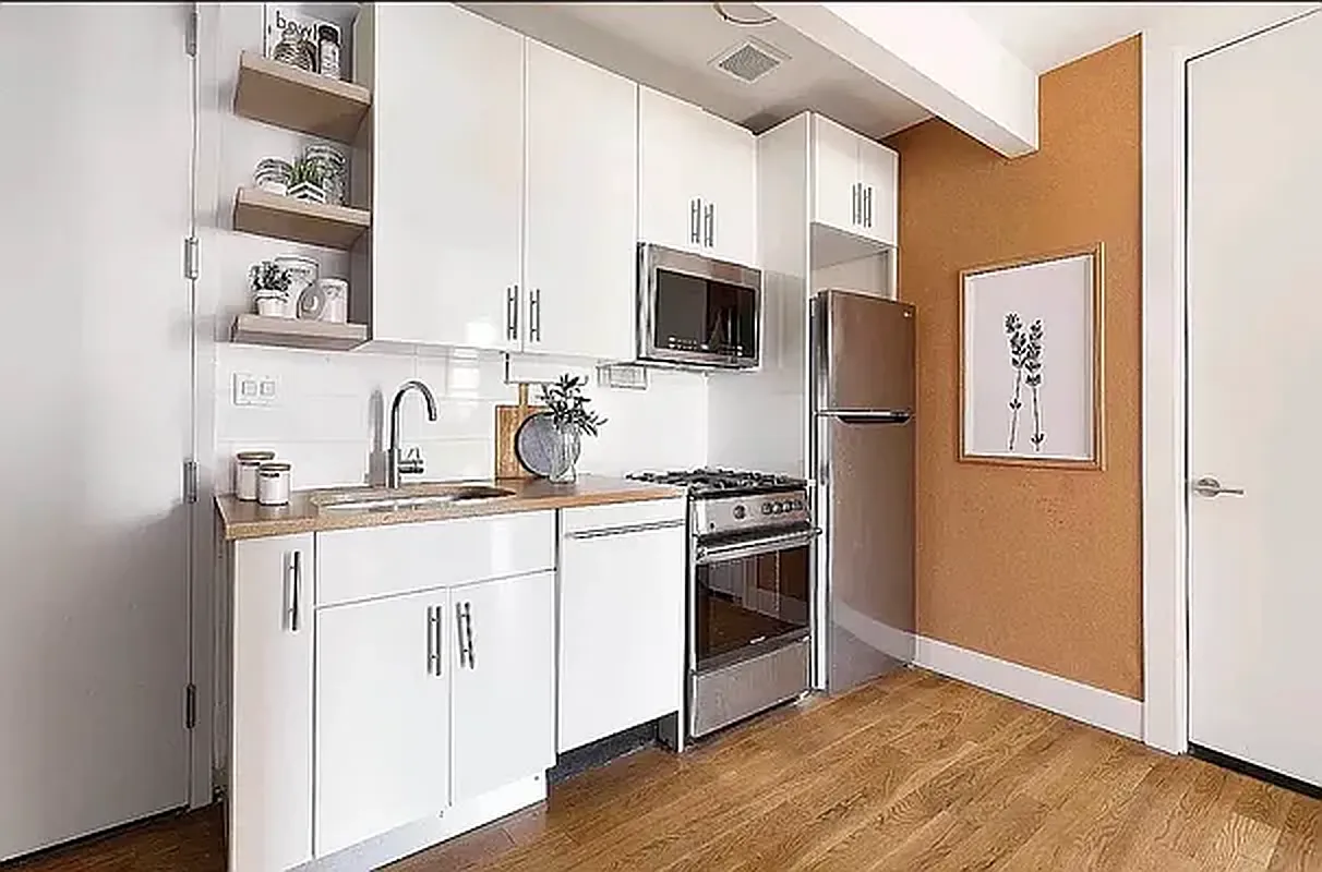 47 Withers Street, Unit 2R Brooklyn, NY 11211 - Photo 2 of 5 a kitchen with stainless steel appliances granite countertop a stove a sink and a microwave