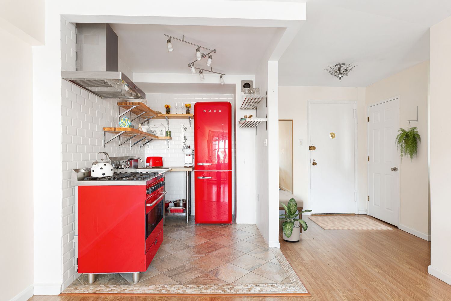 a spacious bedroom with a large bed and a wooden floor