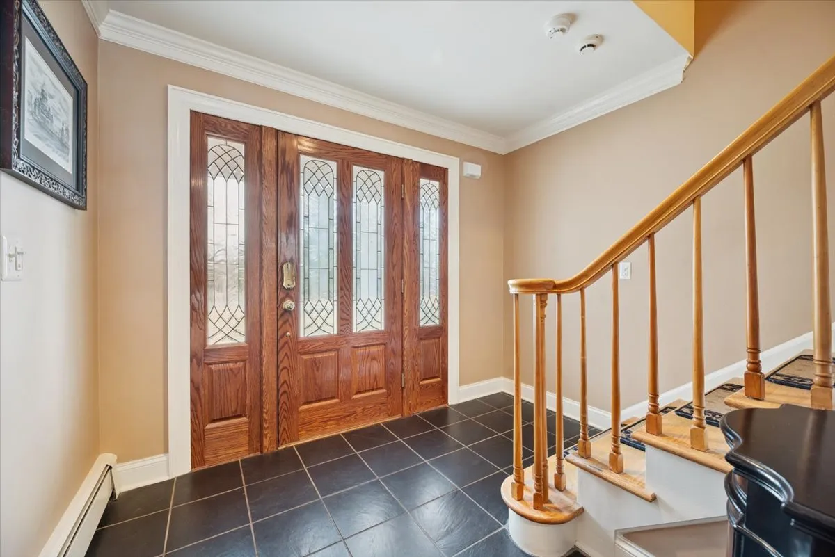 a view of an entryway with workspace and hallway