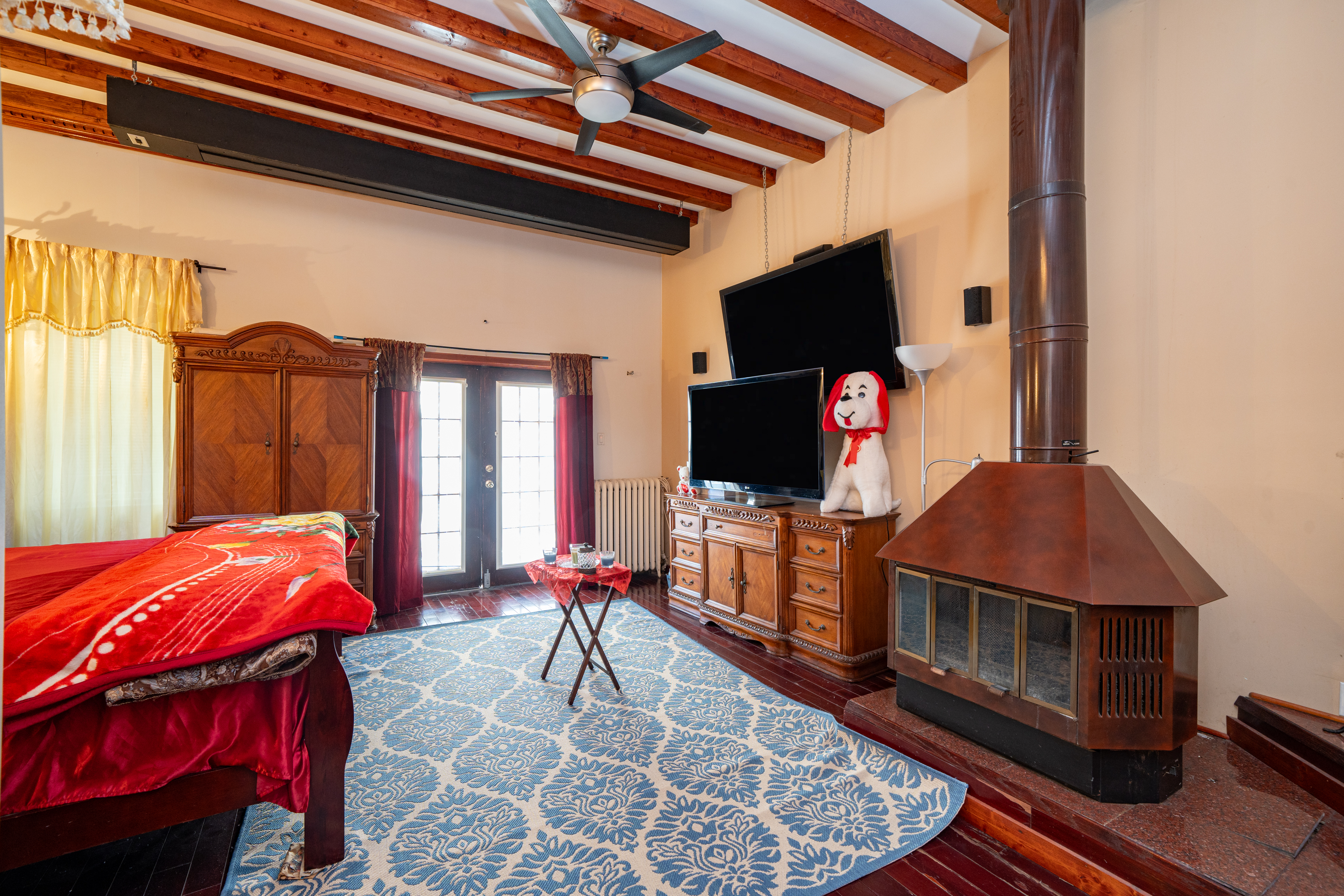 415 84th Street Brooklyn, NY 11209 - Photo 13 of 17 a bedroom with a bed and a flat screen tv