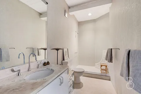 a bathroom with a double vanity sink and a mirror