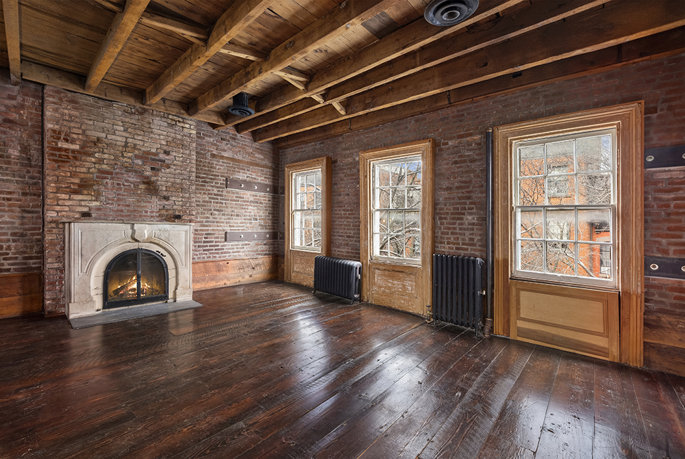 262 West 11th Street Manhattan, NY 10014 - Photo 12 of 27 an empty room with wooden floor fireplace and windows
