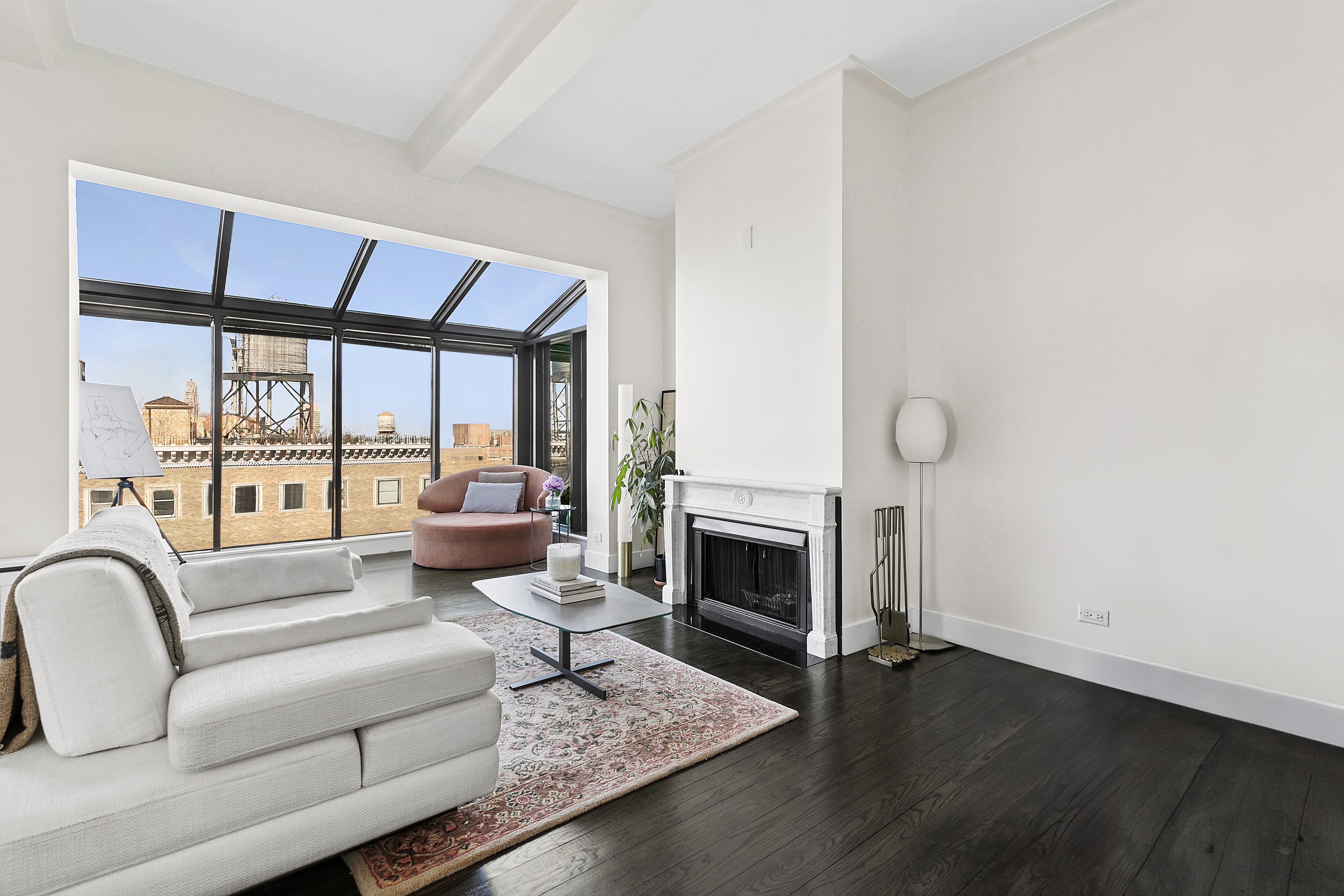310 West 106th Street, Unit PH17B Manhattan, NY 10025 - Photo 8 of 9 a living room with furniture a fireplace and a floor to ceiling window