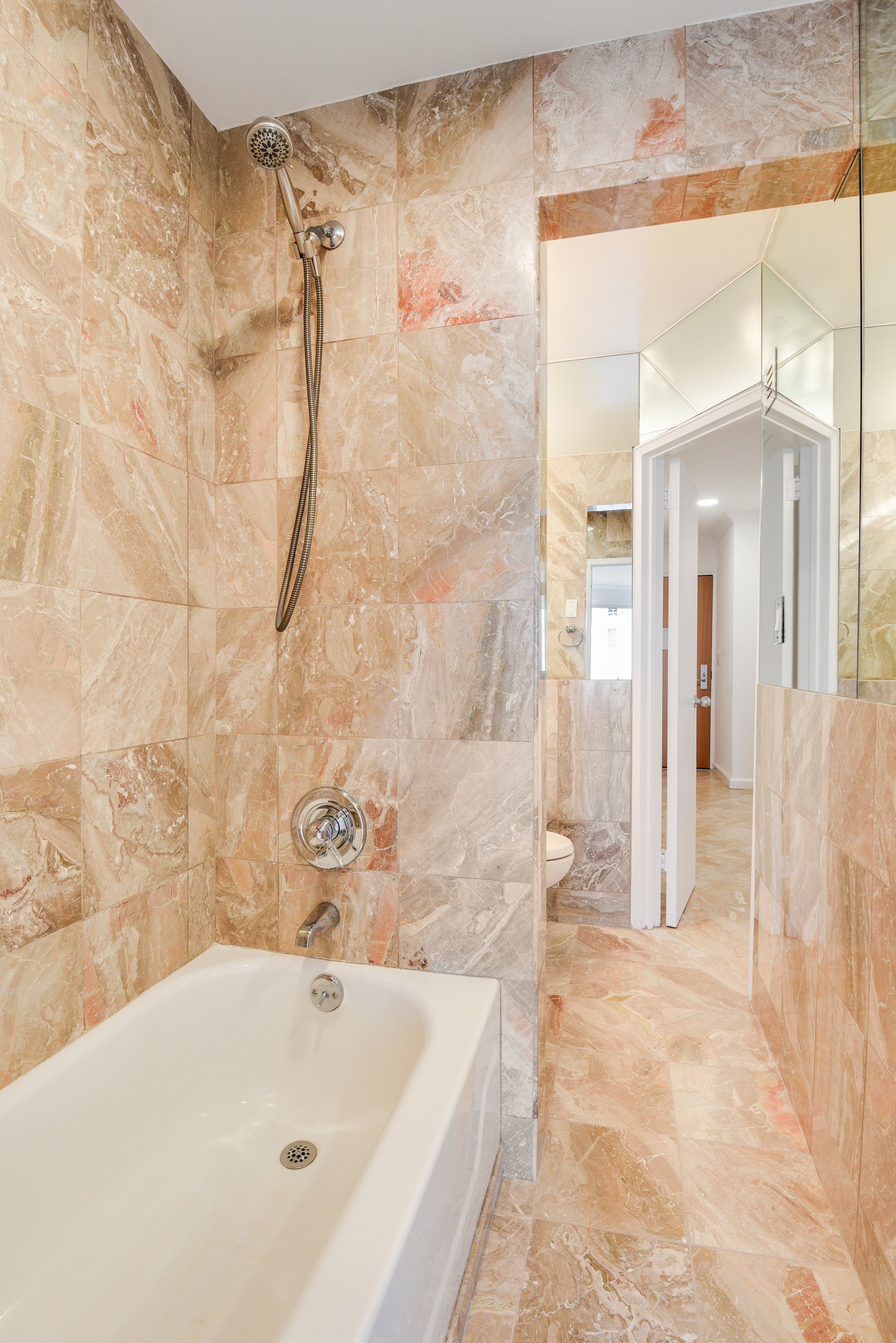 200 Central Park South, Unit 29C Manhattan, NY 10019 - Photo 18 of 23 a bathroom with a bathtub and a shower