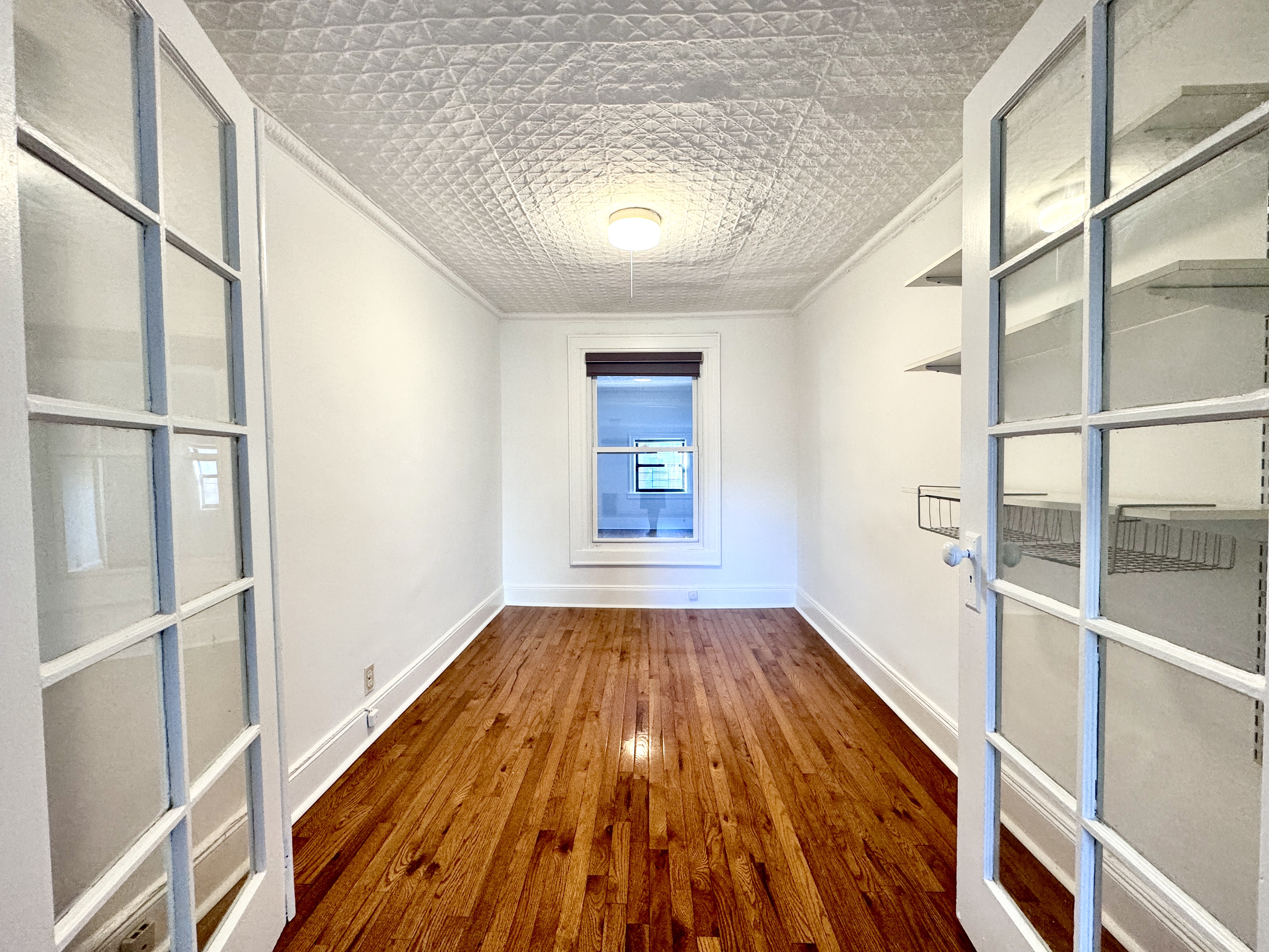 195 Court Street, Unit 4 Brooklyn, NY 11201 - Photo 6 of 11 a view of empty room with wooden floor and fan