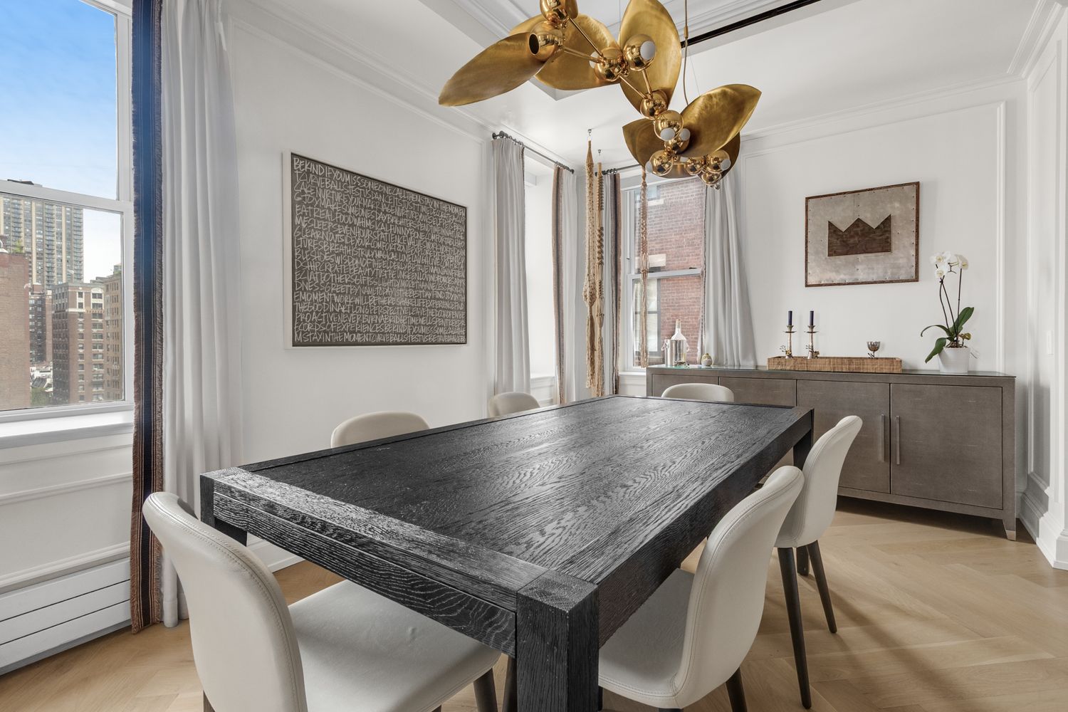 344 West 72nd Street, Unit 1008 Manhattan, NY 10023 - Photo 16 of 35 a dining room with a table and chairs