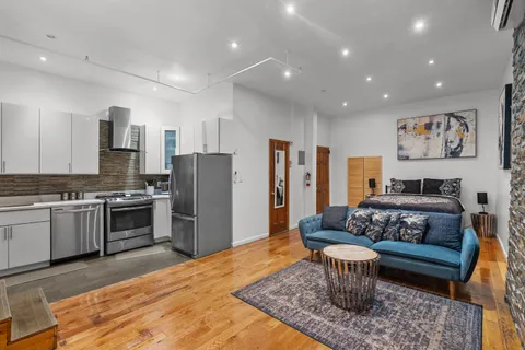 a kitchen with stainless steel appliances granite countertop a refrigerator and a stove top oven