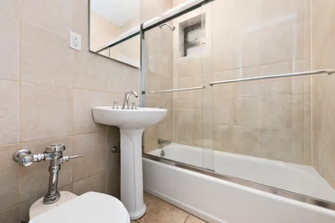 a bathroom with a sink mirror toilet and bathtub