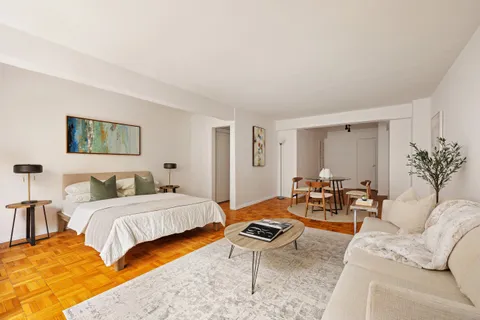 a bedroom with a bed and a couch