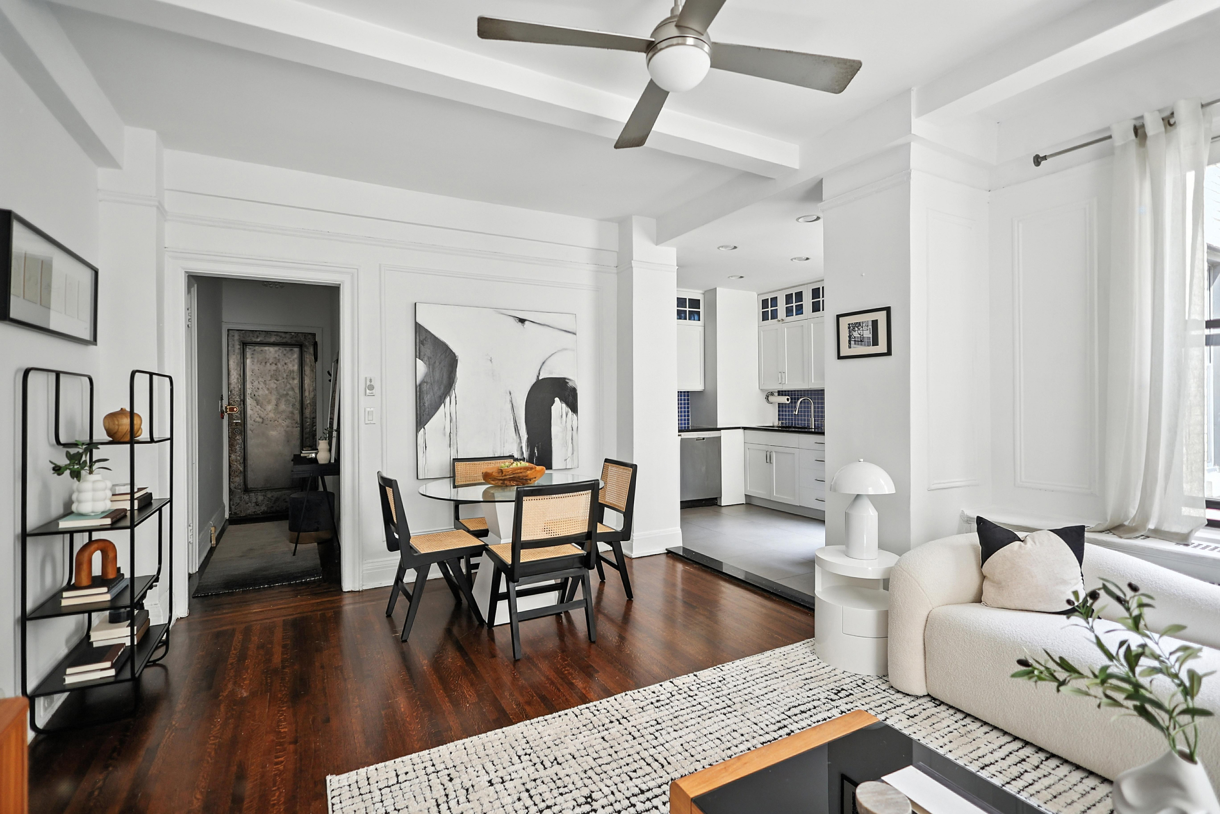 215 West 75th Street, Unit 6B Manhattan, NY 10023 - Photo 4 of 12 a living room with furniture and a wooden floor