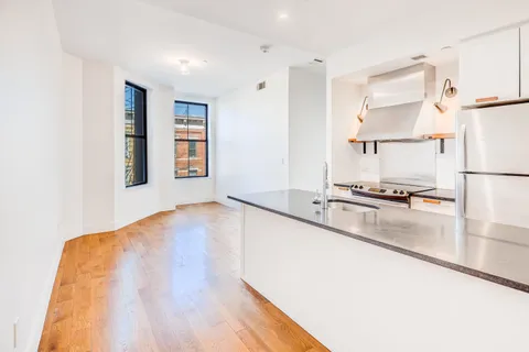 a view of a kitchen with a sink and a window