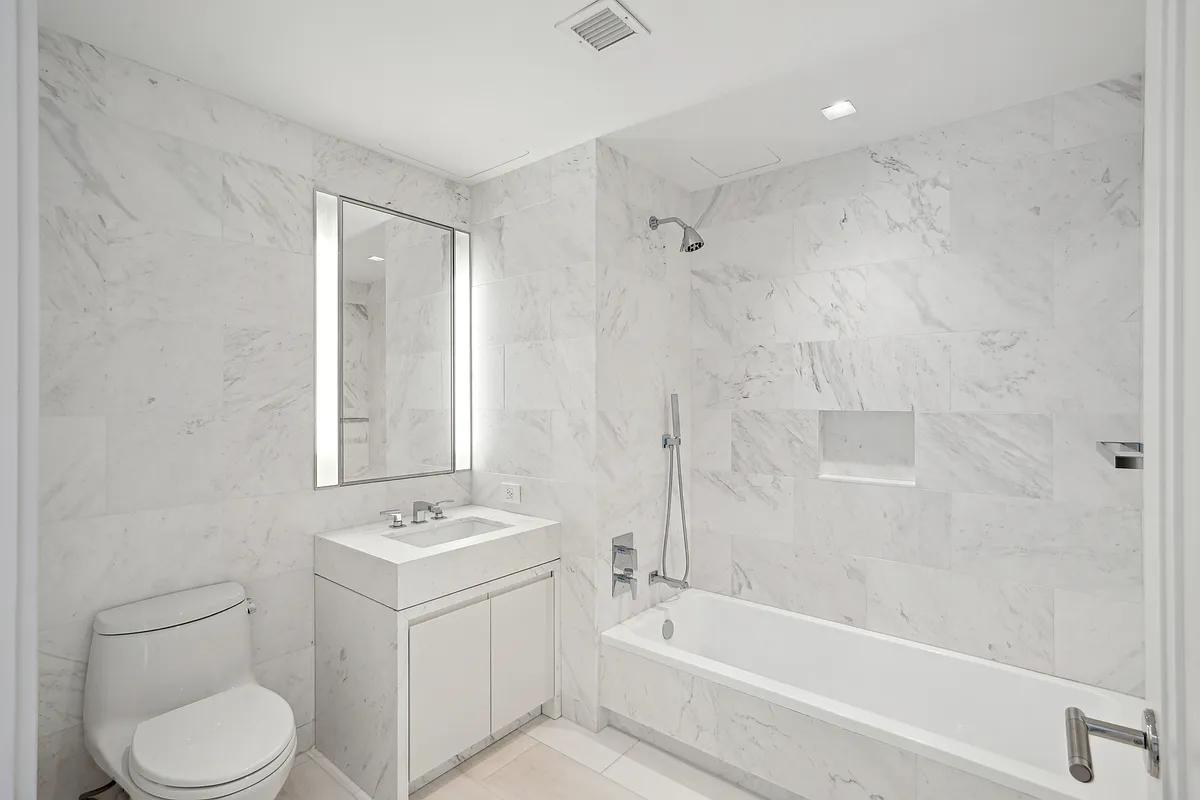 269 West 87th Street, Unit 7B Manhattan, NY 10024 - Photo 9 of 21 a bathroom with a sink toilet a vanity and bathtub