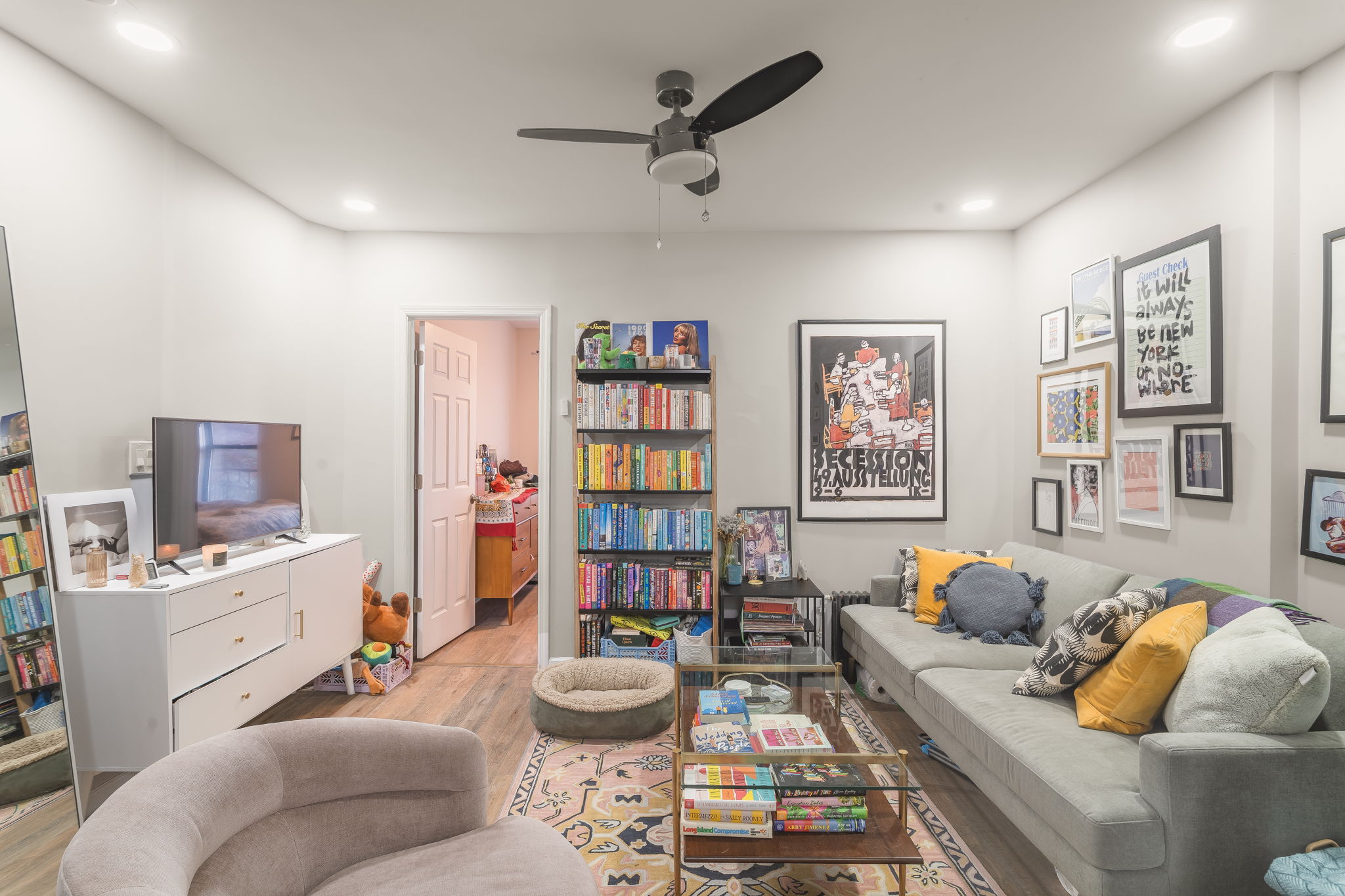 43 Underhill Avenue, Unit B2 Brooklyn, NY 11238 - Photo 3 of 10 a living room with furniture and book shelf