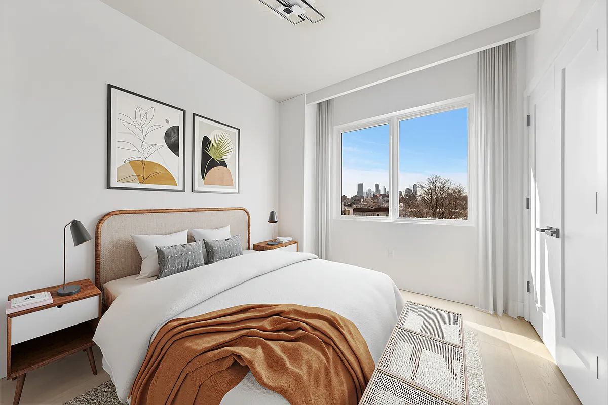 12-16 30th Avenue, Unit 205 Queens, NY 11102 - Photo 6 of 15 a bedroom with a bed and a painting on the wall