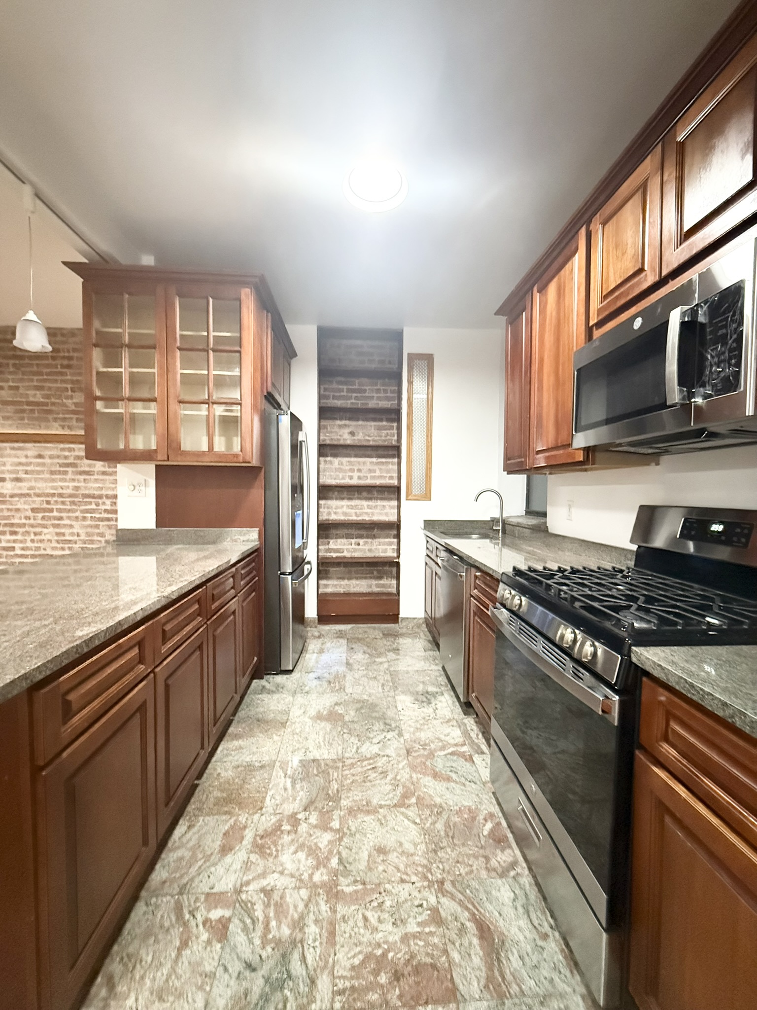 839 West End Avenue, Unit 3D Manhattan, NY 10025 - Photo 1 of 10 a large kitchen with stainless steel appliances granite countertop a stove and a sink