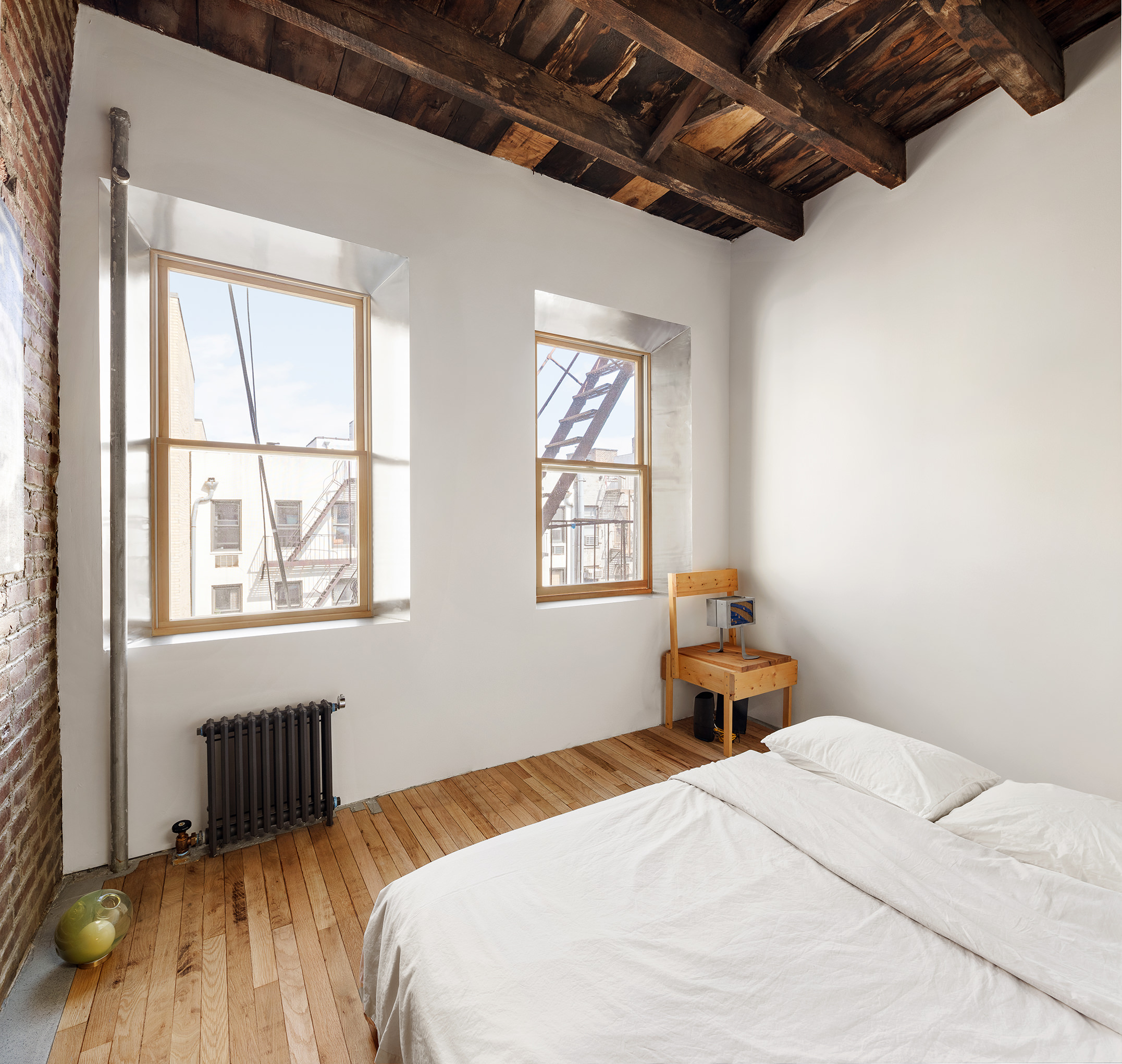186 East 2nd Street, Unit 16 Manhattan, NY 10009 - Photo 2 of 17 a bedroom with a bed and a window