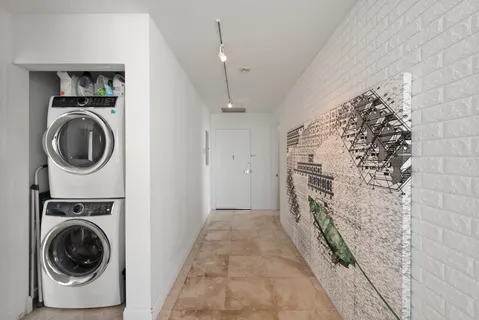 a view of a hallway with washer and dryer