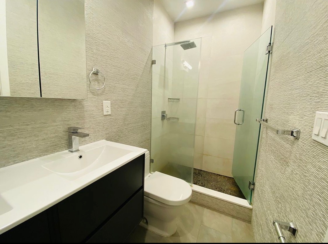 133 East 35th Street, Unit 3 Manhattan, NY 10016 - Photo 13 of 16 a bathroom with a sink a toilet and shower