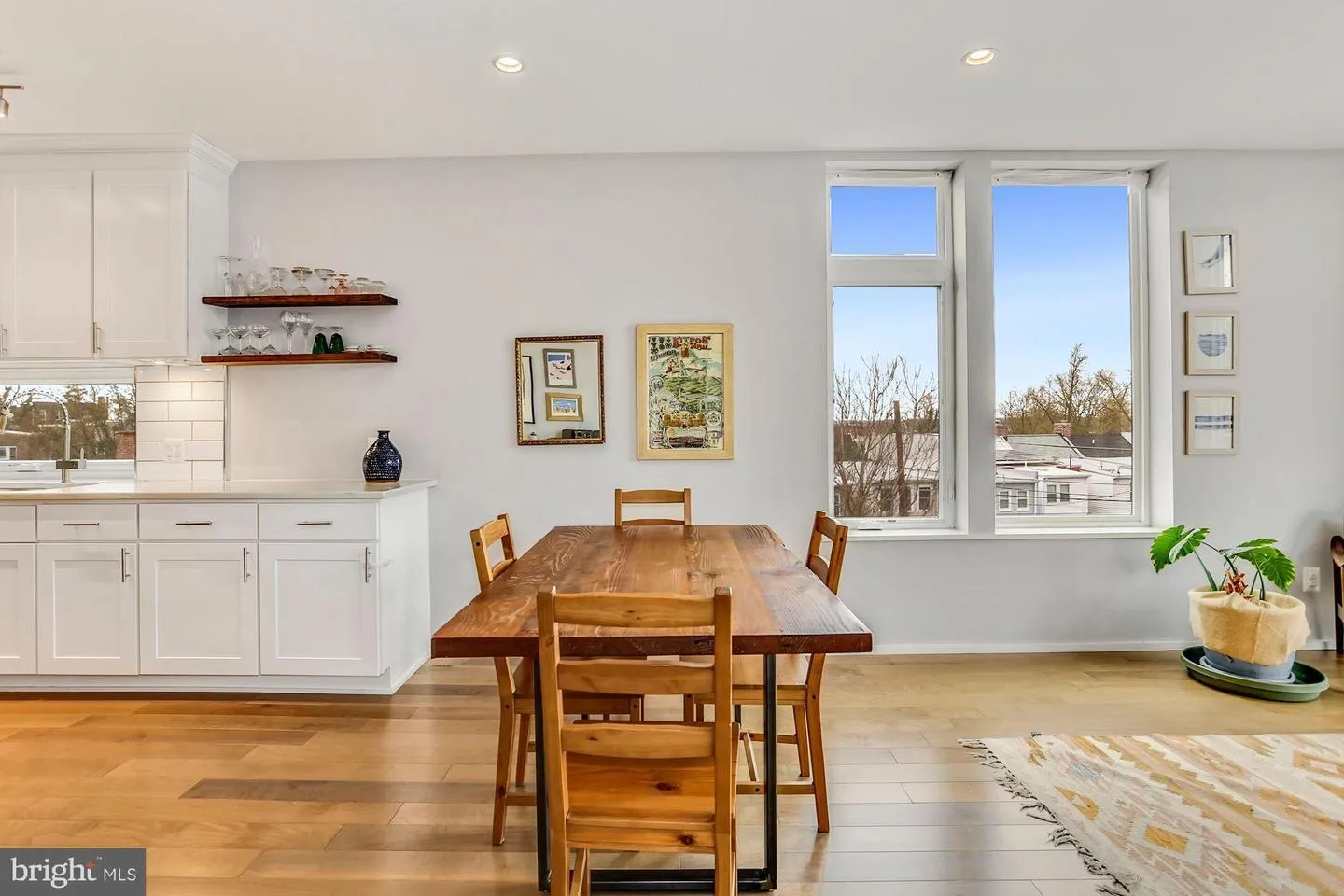 a dining room with kitchen island a table and chairs