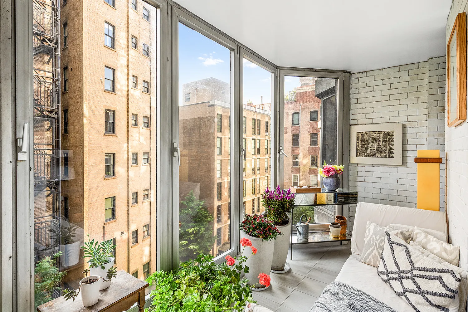 a living room filled with furniture and a potted plant