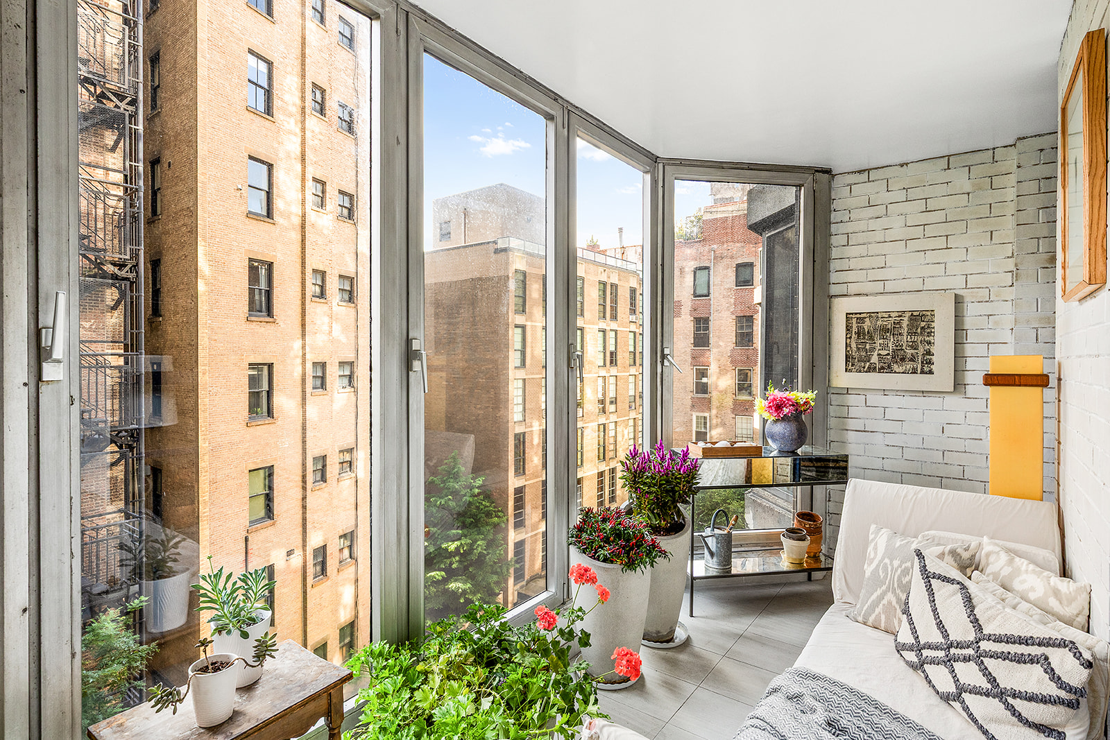 37 West 12th Street, Unit 6G Manhattan, NY 10011 - Photo 7 of 17 a living room filled with furniture and a potted plant