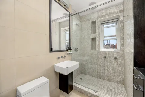 a bathroom with a sink toilet and shower