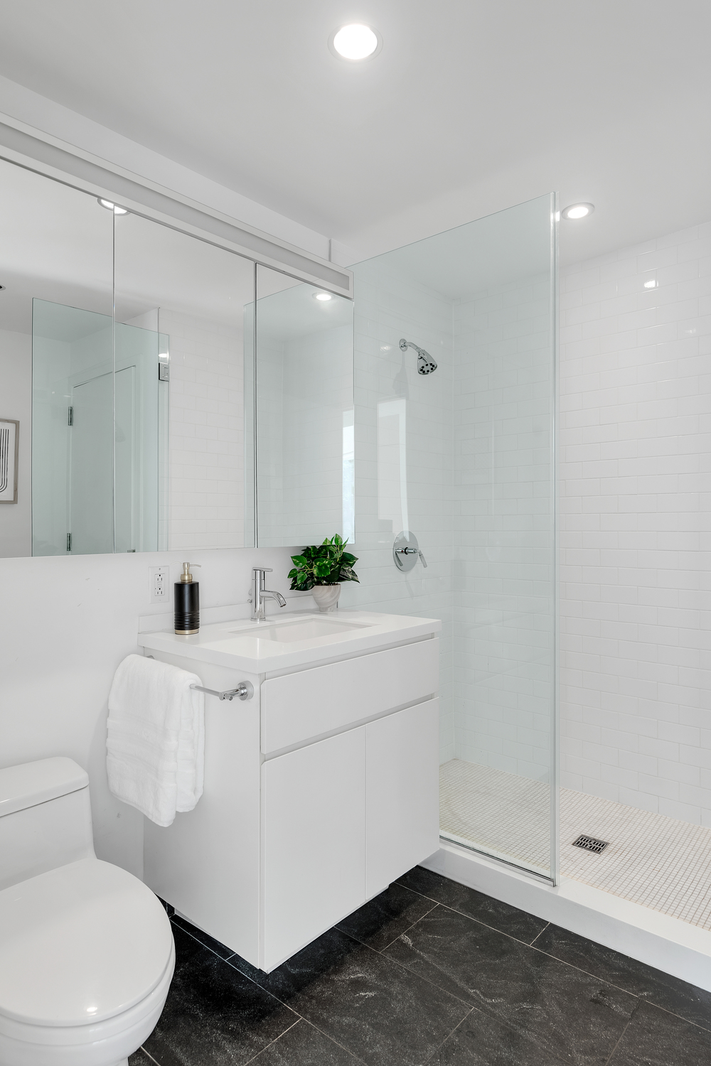 425 West 53rd Street, Unit 419 Manhattan, NY 10019 - Photo 6 of 18 a bathroom with a sink a toilet and shower