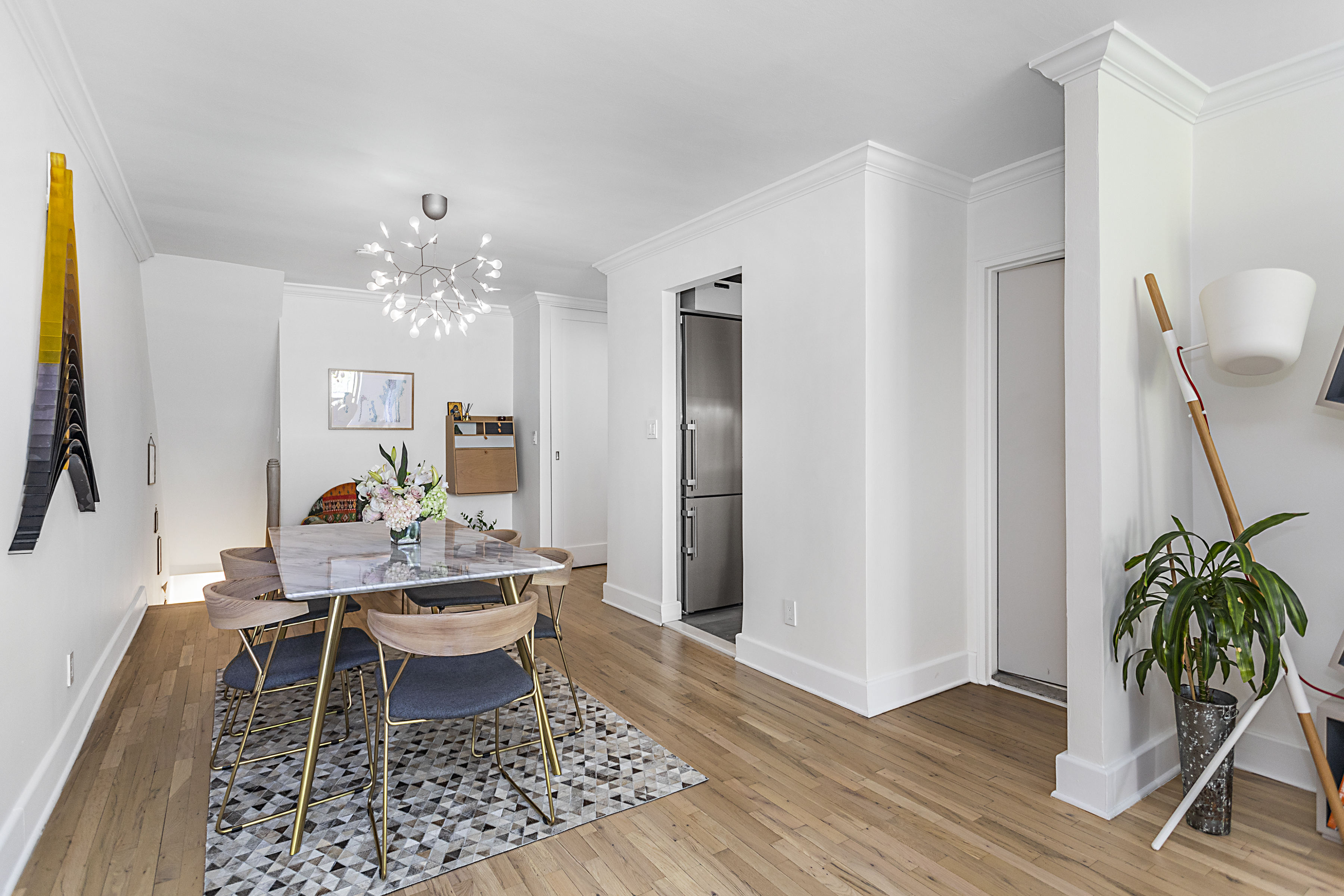 250 West 15th Street, Unit 3C Manhattan, NY 10011 - Photo 4 of 9 a living room with furniture and a chandelier