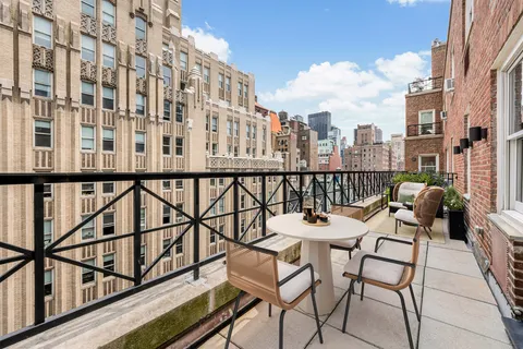 a balcony with table and chairs