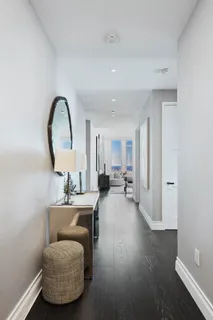 a living room with furniture and a mirror