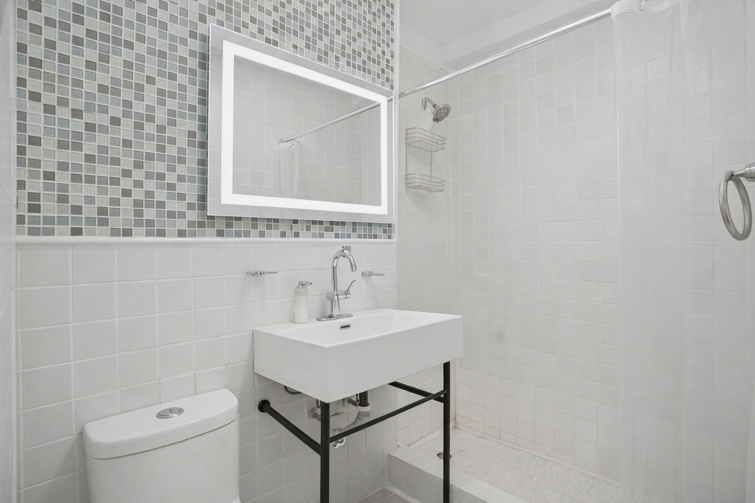 141 East 55th Street, Unit 4C Manhattan, NY 10022 - Photo 5 of 7 a bathroom with a sink a toilet and a mirror