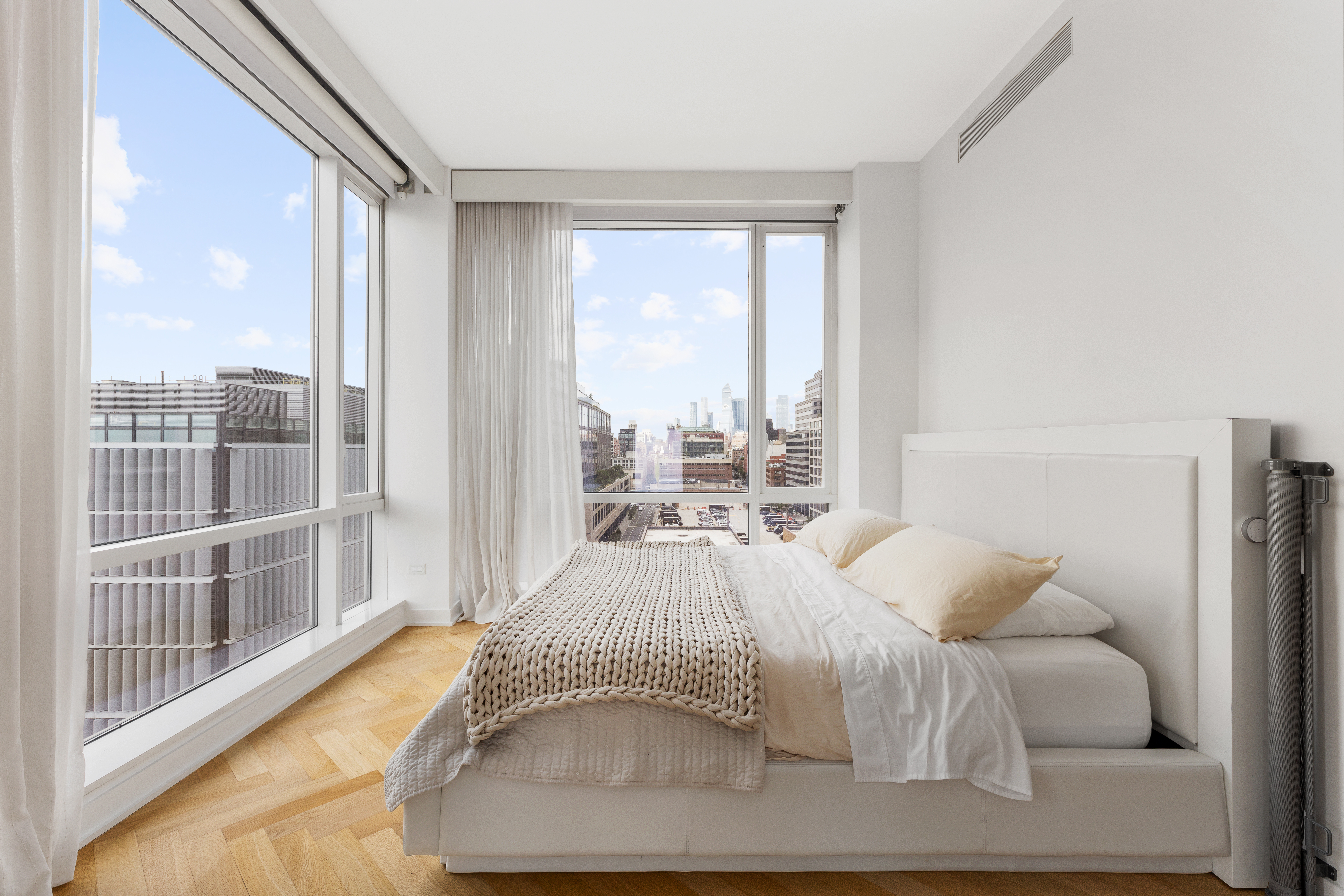 330 Spring Street, Unit 11B Manhattan, NY 10013 - Photo 6 of 10 a bedroom with a bed and a large window