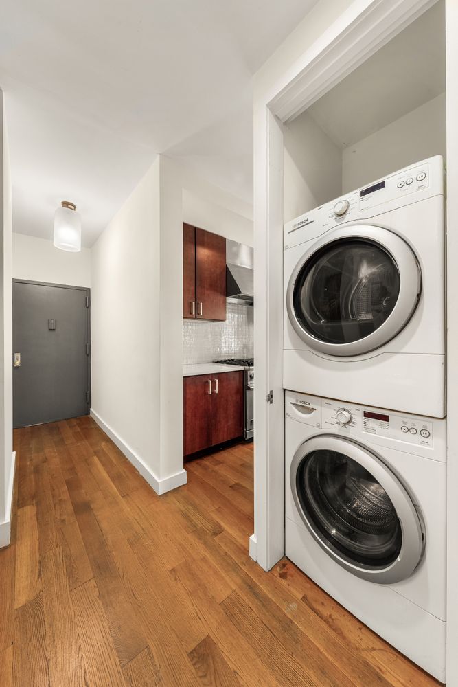 a view of a storage & utility room with a washer dryer