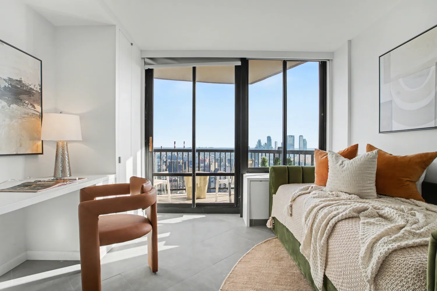 a living room with furniture and a floor to ceiling window