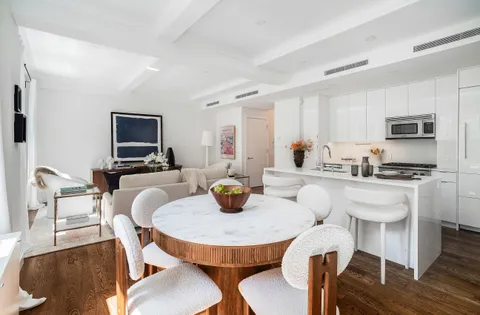 a kitchen with a dining table and chairs