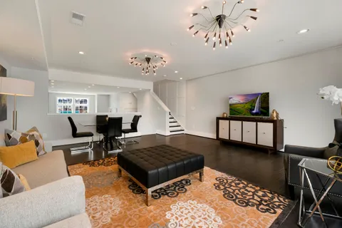 a living room with furniture rug and window