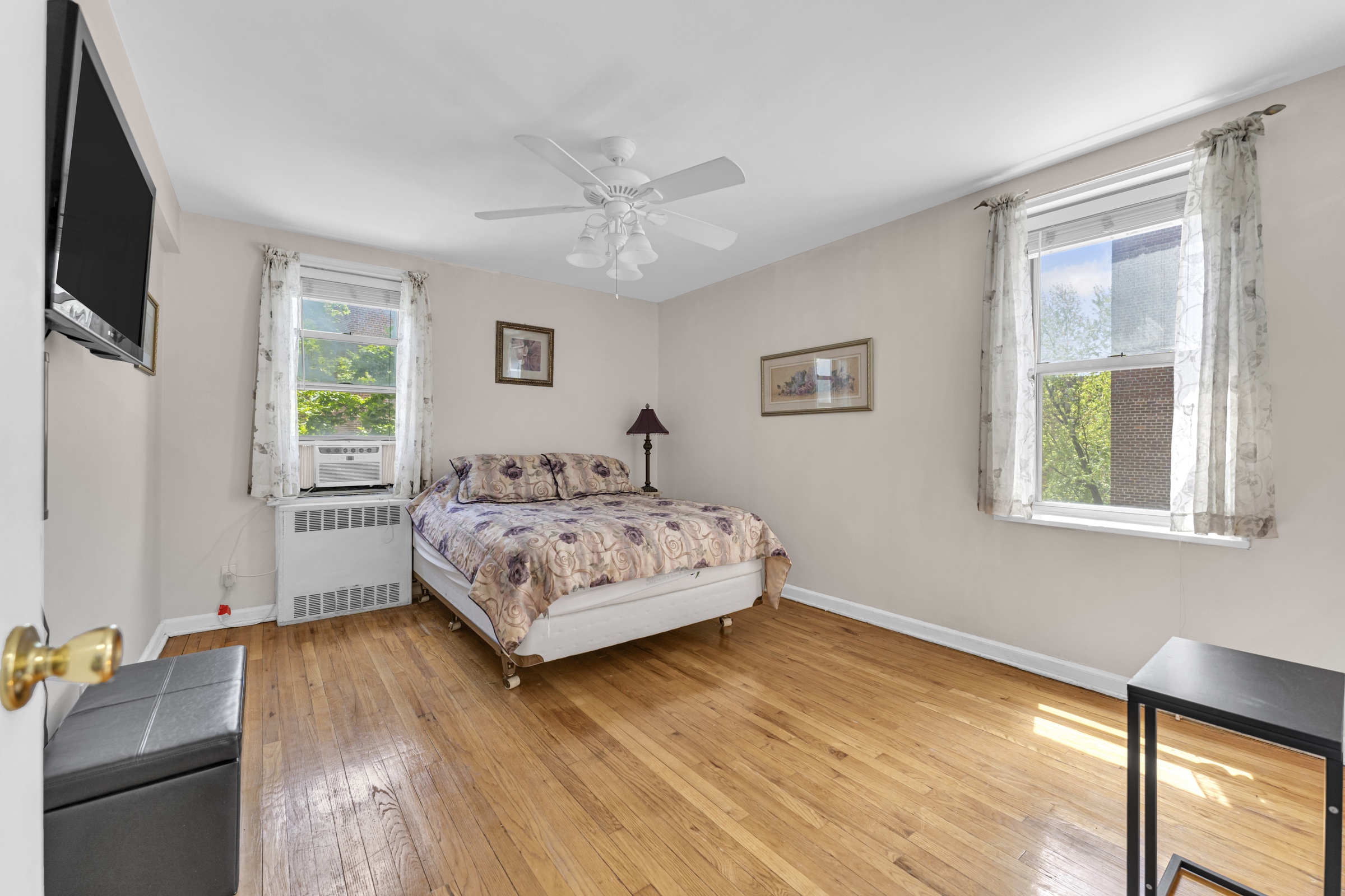 5614 Netherland Avenue, Unit 3E Bronx, NY 10471 - Photo 8 of 13 a bedroom with a bed and wooden floor