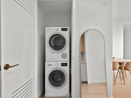 a view of a hallway with washer and dryer